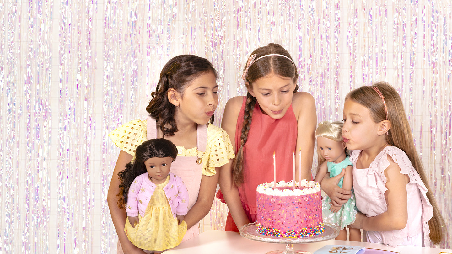 3 little girls holding dolls that look similar to them