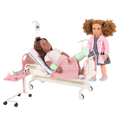 Two 18-inch dolls with hospital gurney playset